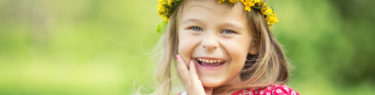 Portrait of happy little girl in spring park