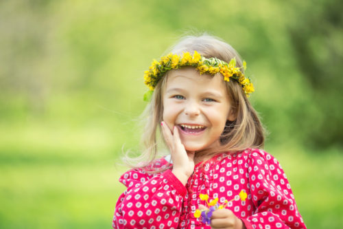 Portrait of happy little girl in spring park
