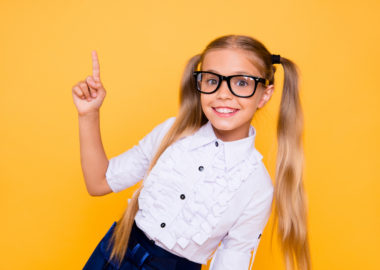 Back to school! First grade junior lifestyle teen concept. Close up studio photo portrait of cute girl gesturing up wearing trendy blouse white outfit isolated bright shine background