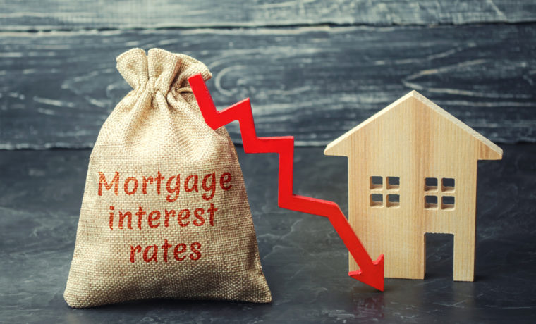 Bag with the money and the word Mortgage interest rates and arrow to down and house. Low interest in mortgages. Reducing interest payments for mortgages. The fall in housing rates on credit. Low housing demand